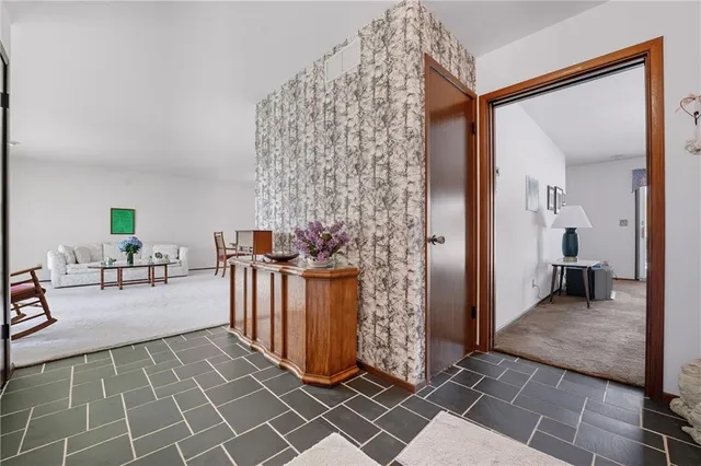 a view of a livingroom with furniture and staircase