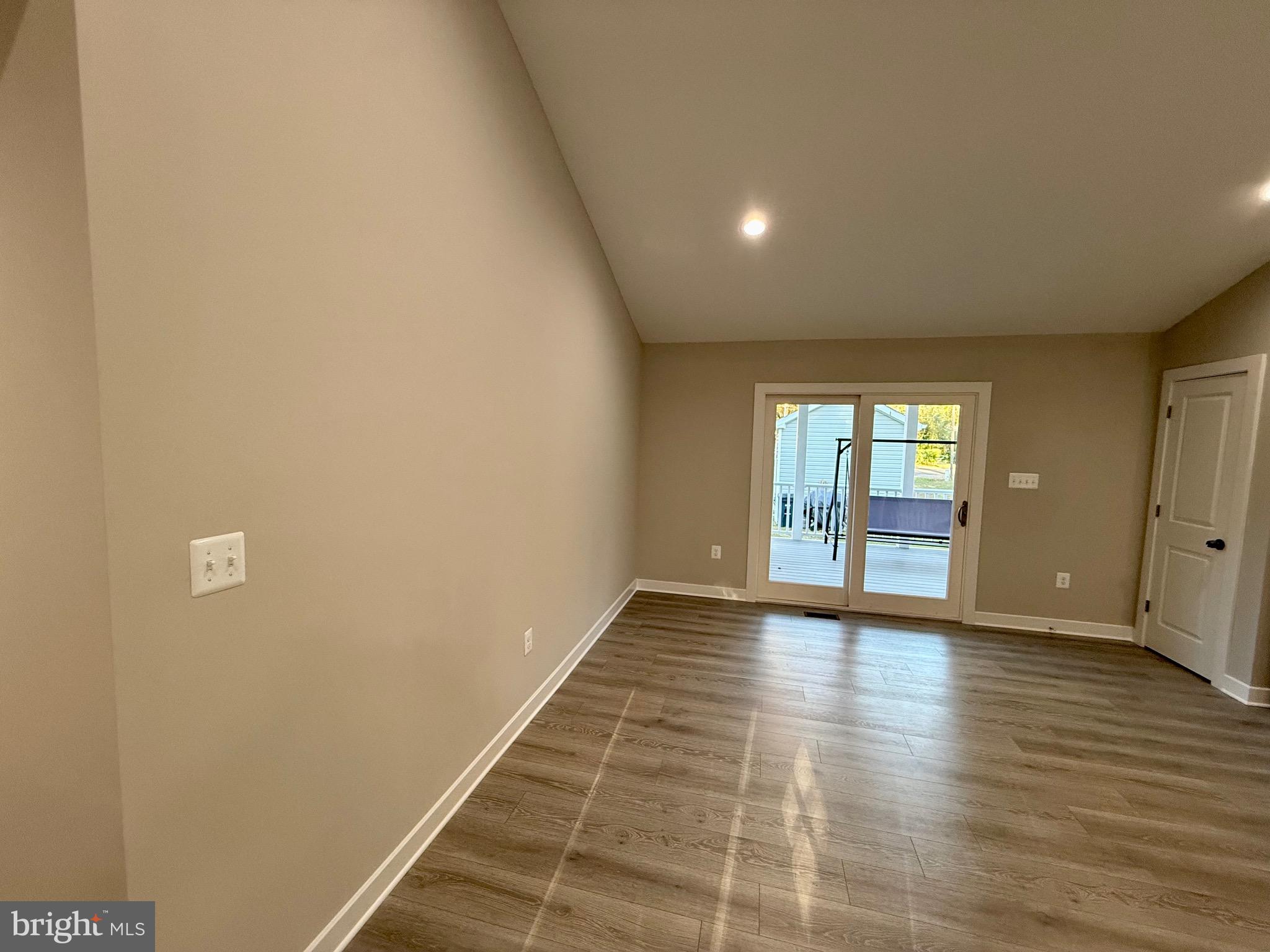 982 Mattox Avenue Colonial Beach, VA 22443 - Photo 12 of 53 a view of an empty room with wooden floor and windows