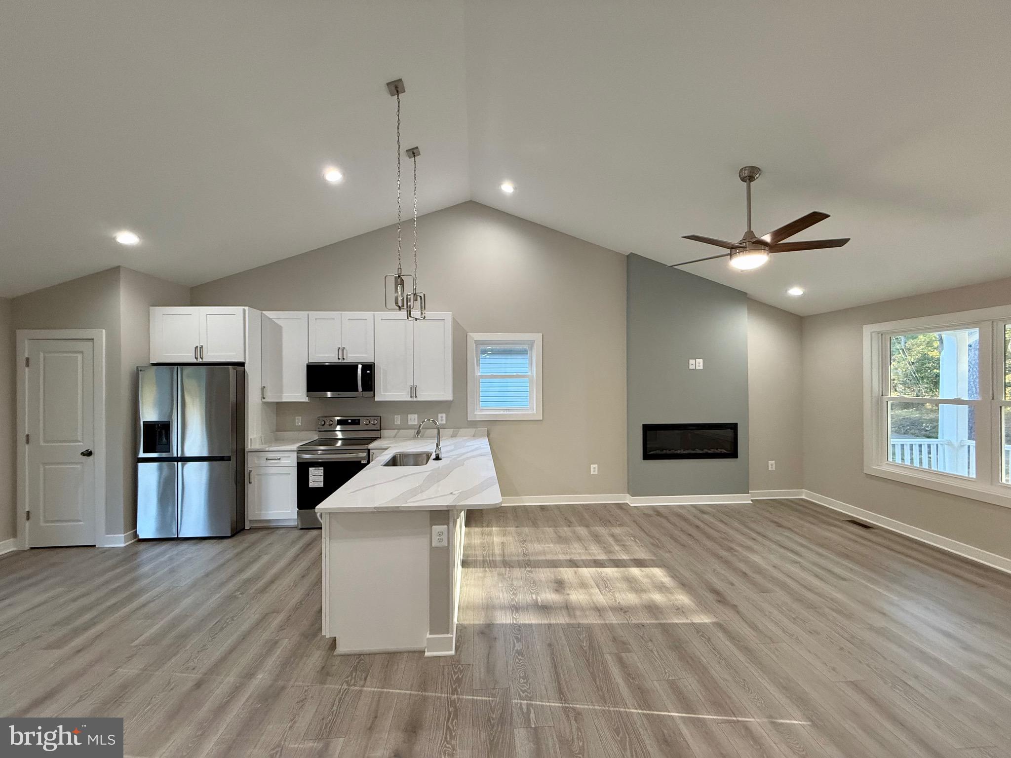 982 Mattox Avenue Colonial Beach, VA 22443 - Photo 14 of 53 a kitchen with stainless steel appliances a refrigerator sink and microwave