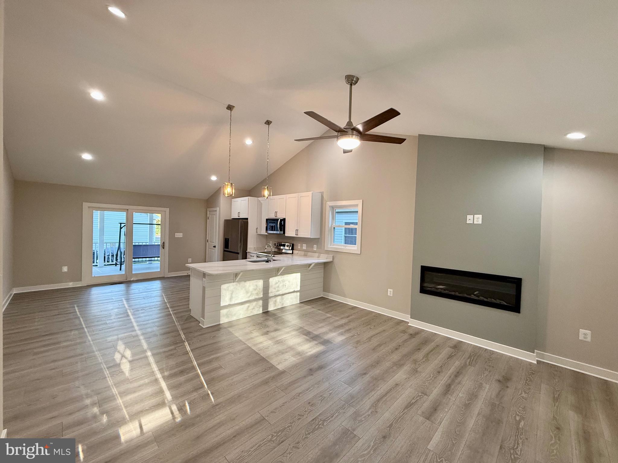 982 Mattox Avenue Colonial Beach, VA 22443 - Photo 16 of 53 a living room with furniture and a ceiling fan