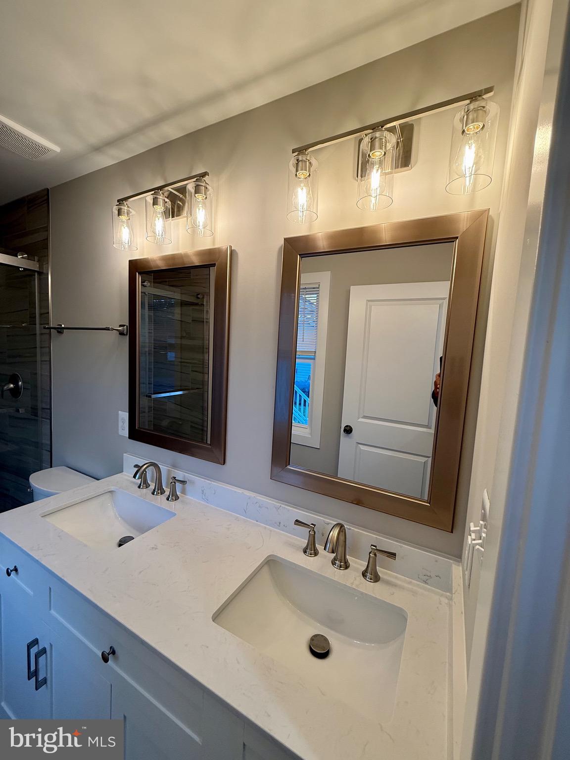 982 Mattox Avenue Colonial Beach, VA 22443 - Photo 20 of 53 a bathroom with double vanity sinks and a mirror