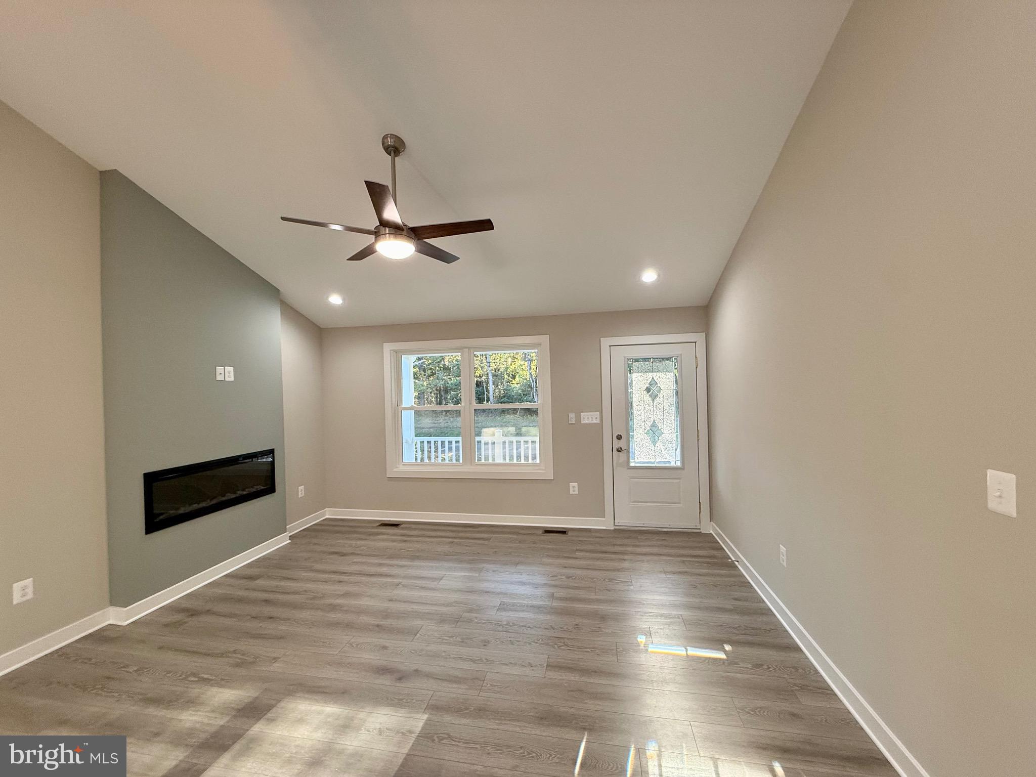 982 Mattox Avenue Colonial Beach, VA 22443 - Photo 9 of 53 a view of an empty room with a window and wooden floor