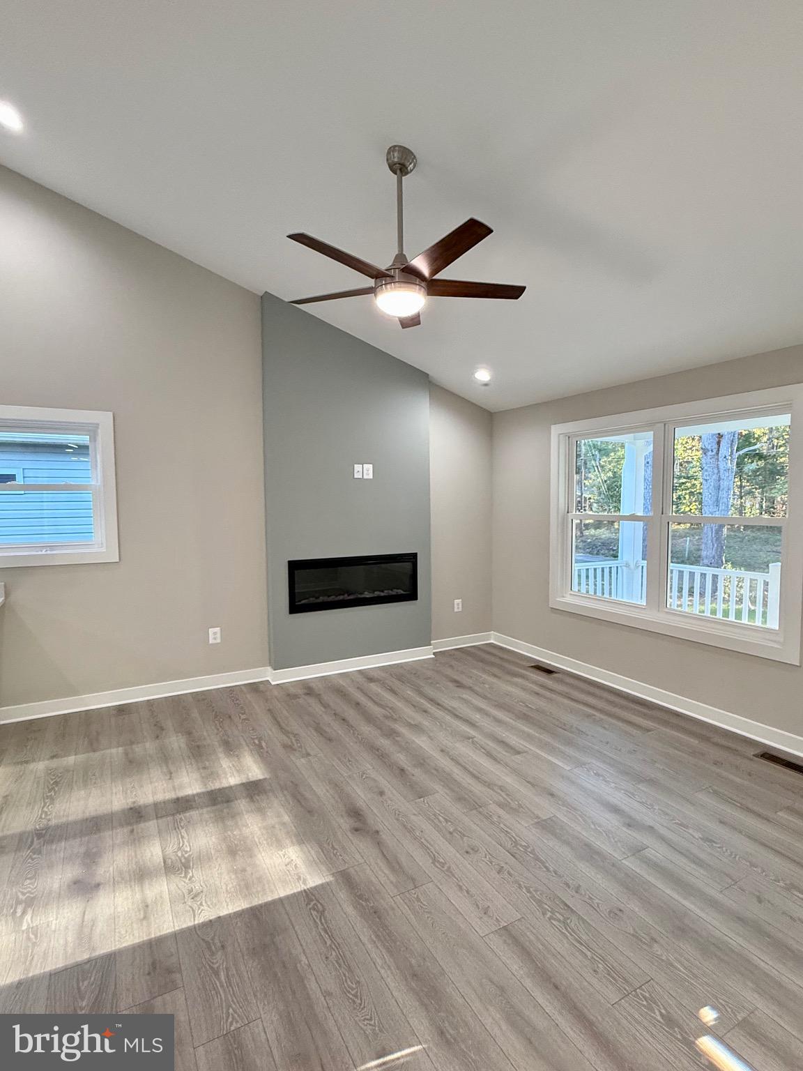 982 Mattox Avenue Colonial Beach, VA 22443 - Photo 10 of 53 a view of an empty room with wooden floor and a window