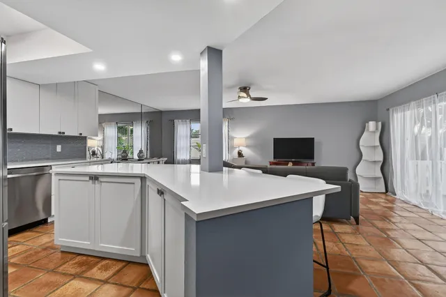 a living room with furniture a window and a flat screen tv