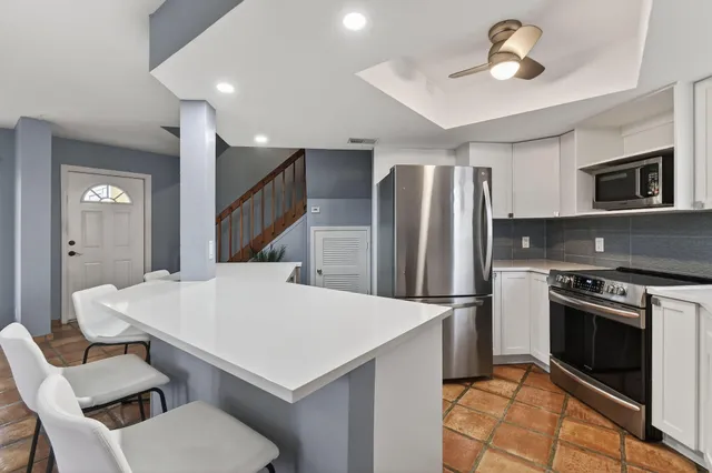 a bathroom with a sink a toilet and shower curtain