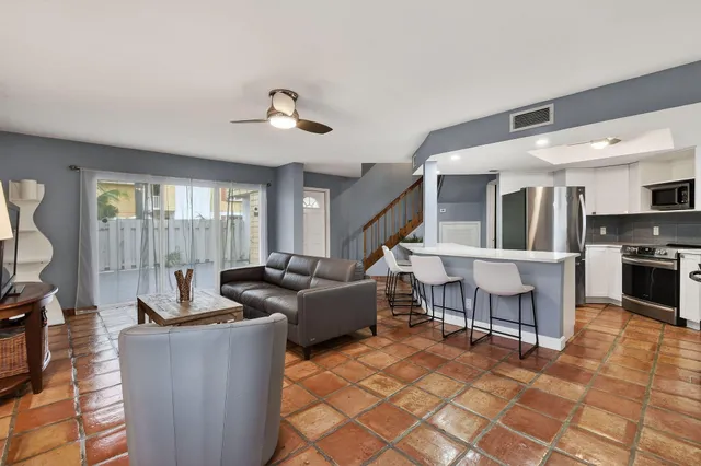 a bedroom with a bed a mirror and a window