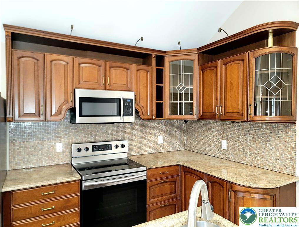 867 Underwood Road West East Stroudsburg, PA 18302 - Photo 3 of 28 a kitchen with stainless steel appliances granite countertop a stove a sink and a microwave