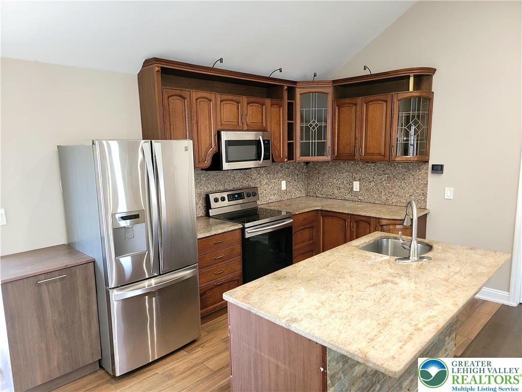 867 Underwood Road West East Stroudsburg, PA 18302 - Photo 4 of 28 a kitchen with stainless steel appliances granite countertop a sink stove microwave and refrigerator