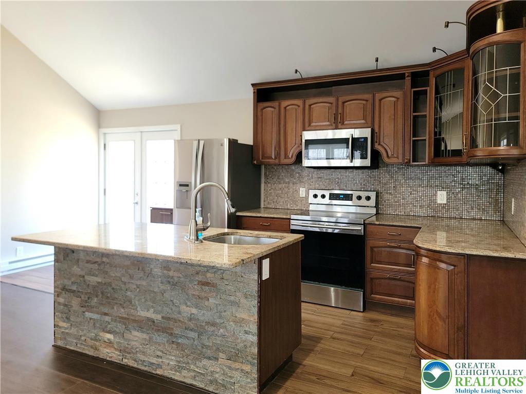 867 Underwood Road West East Stroudsburg, PA 18302 - Photo 5 of 28 a kitchen with stainless steel appliances granite countertop a sink stove and oven