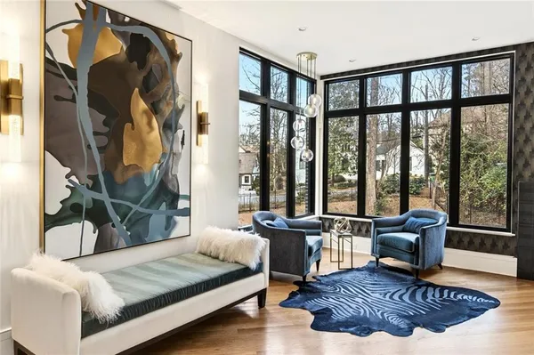 a dining room with furniture a chandelier and a flat screen tv