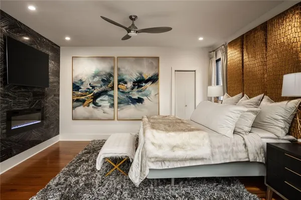 a bedroom with a bed and wooden floor