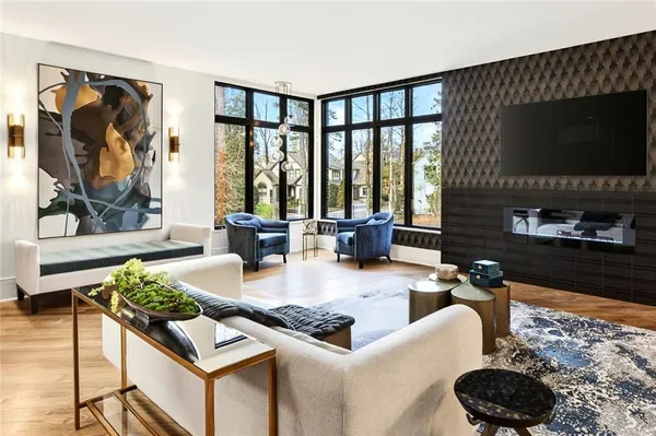 a living room with furniture tv and a flat screen tv