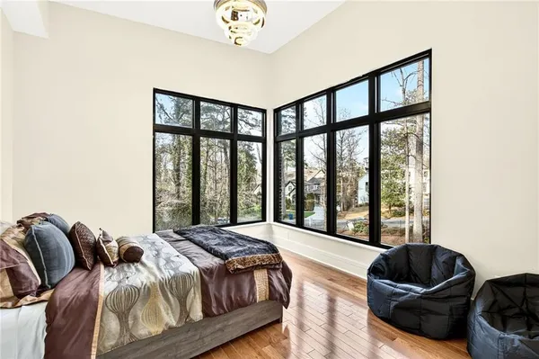a living room with furniture and floor to ceiling windows
