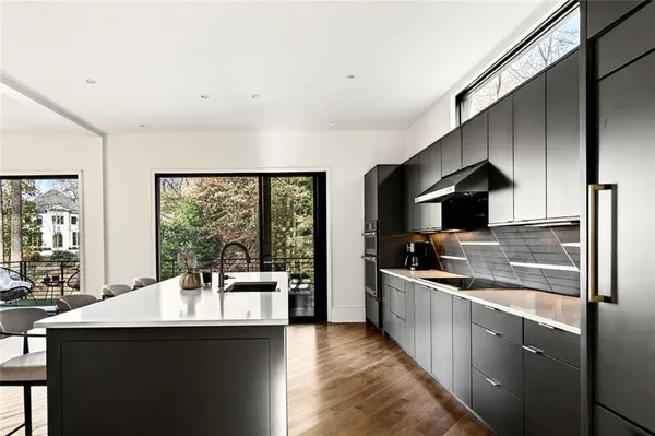 a kitchen with stainless steel appliances a sink stove and cabinets