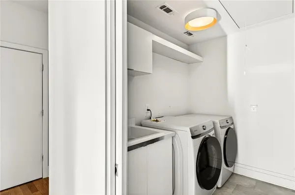 a living room with furniture and floor to ceiling windows