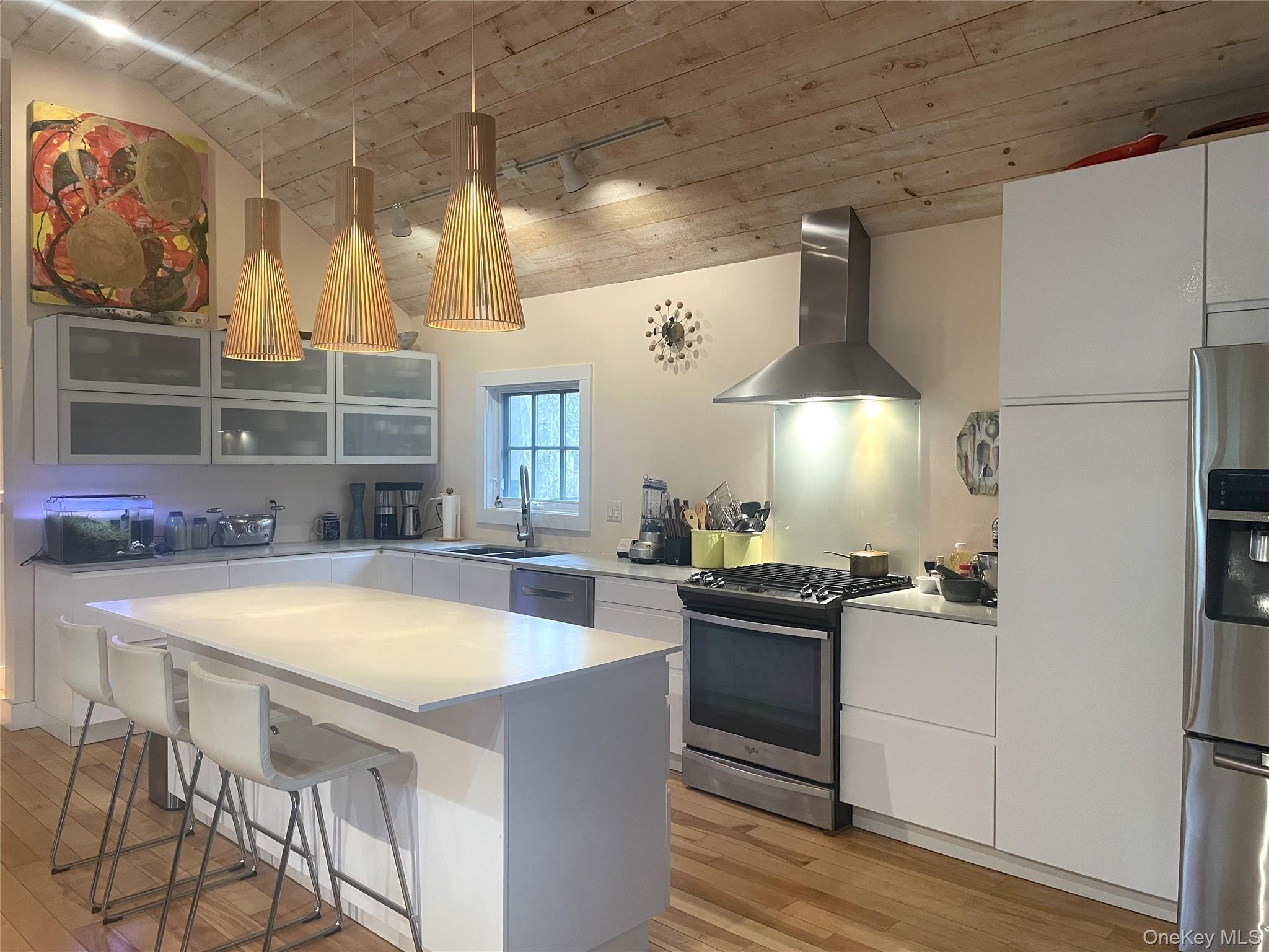 21 North Sea Road Southampton, NY 11968 - Photo 4 of 15 a kitchen with a table chairs stove and refrigerator