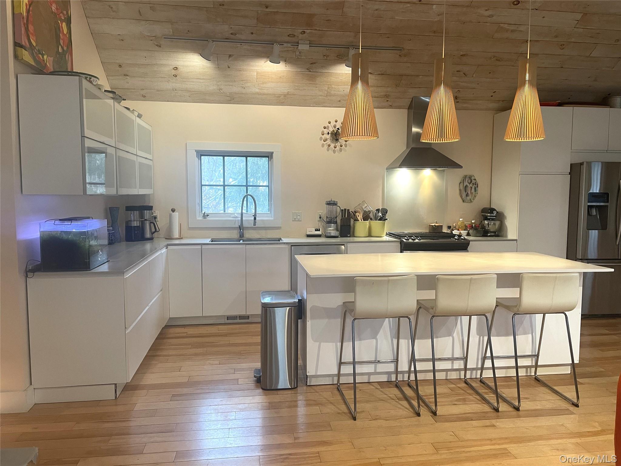 21 North Sea Road Southampton, NY 11968 - Photo 7 of 15 a kitchen with a sink cabinets and wooden floor