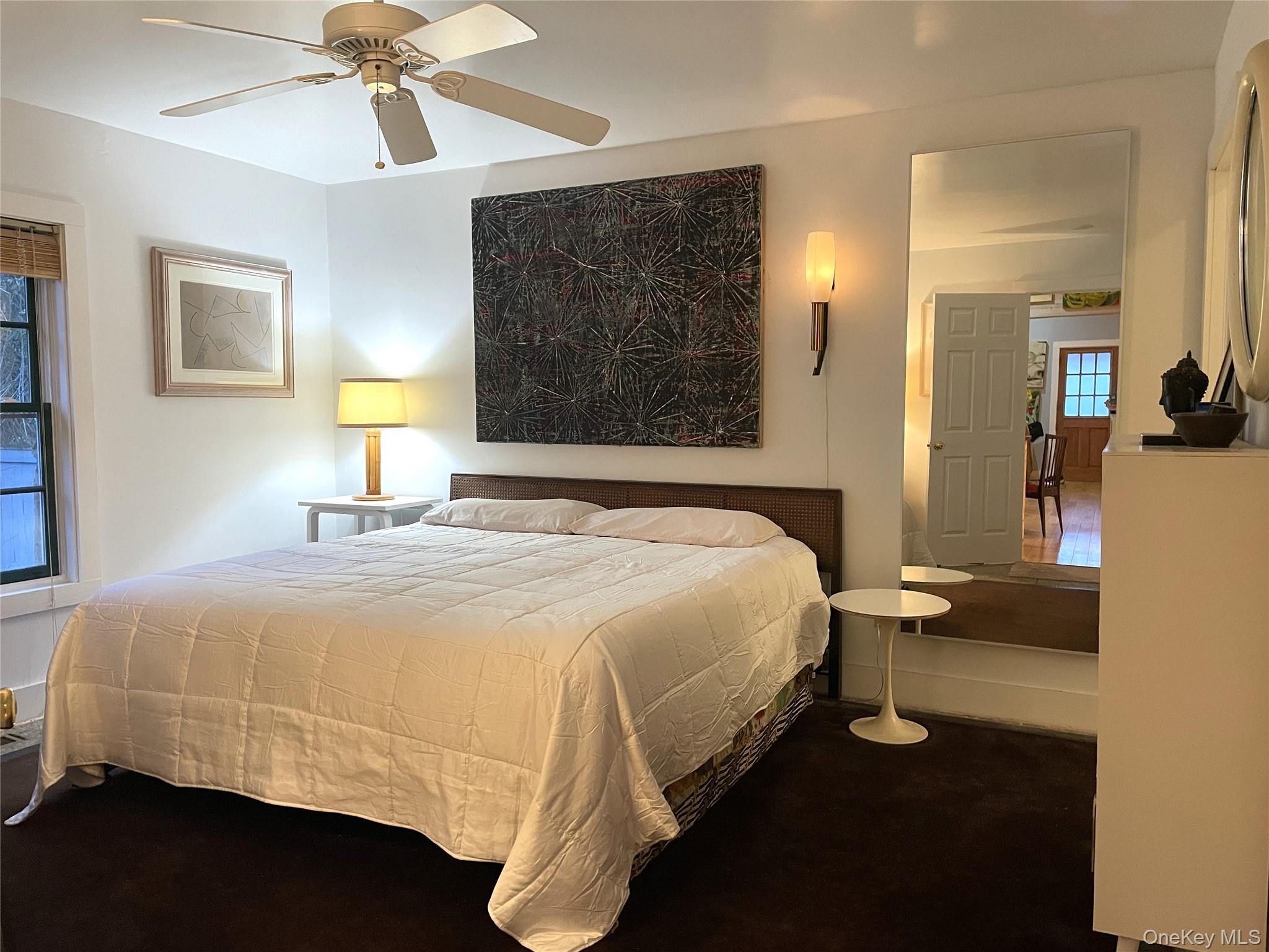 21 North Sea Road Southampton, NY 11968 - Photo 9 of 15 a bedroom with a bed and a lamp