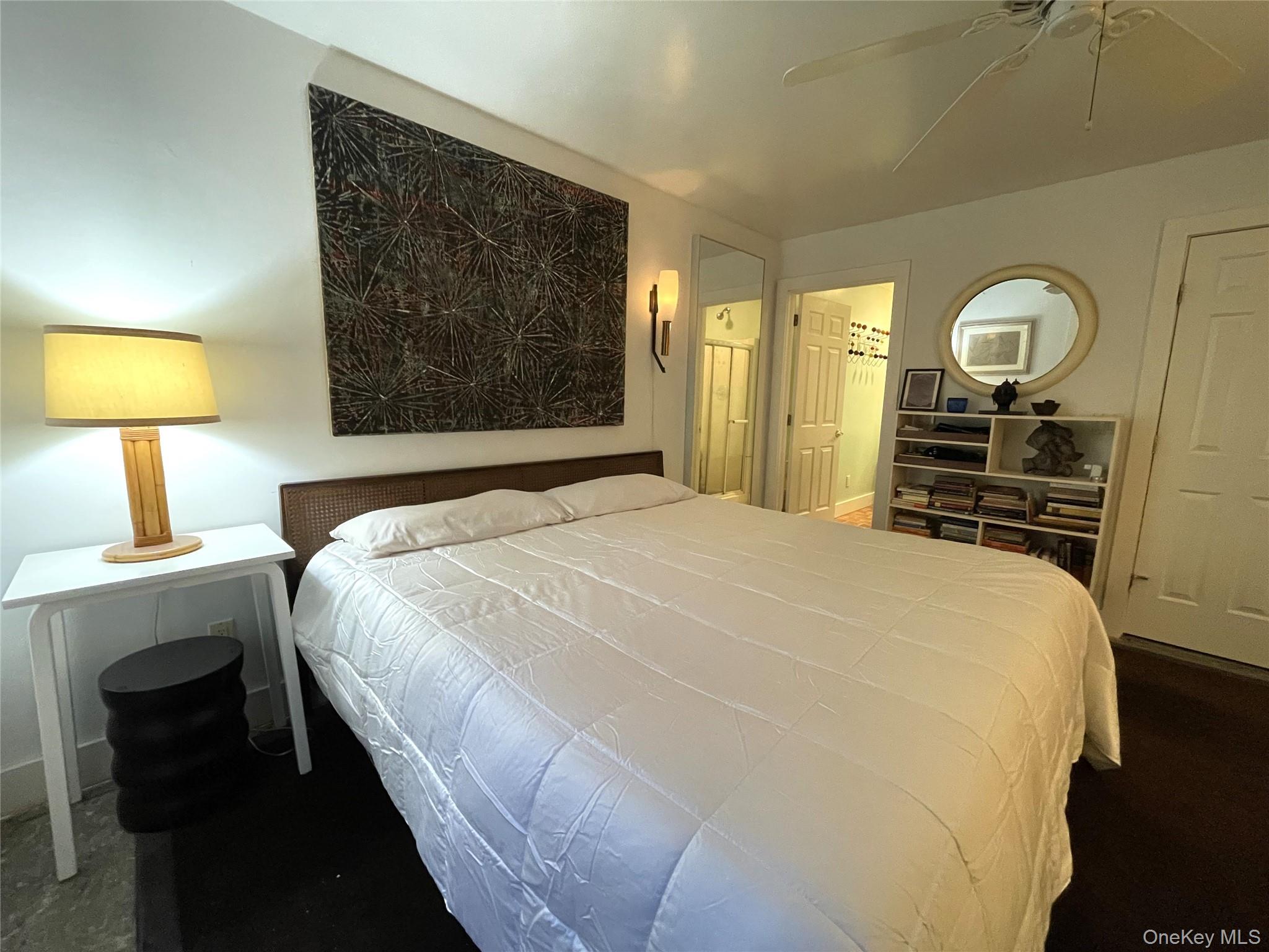 21 North Sea Road Southampton, NY 11968 - Photo 10 of 15 a bedroom with a bed and a lamp