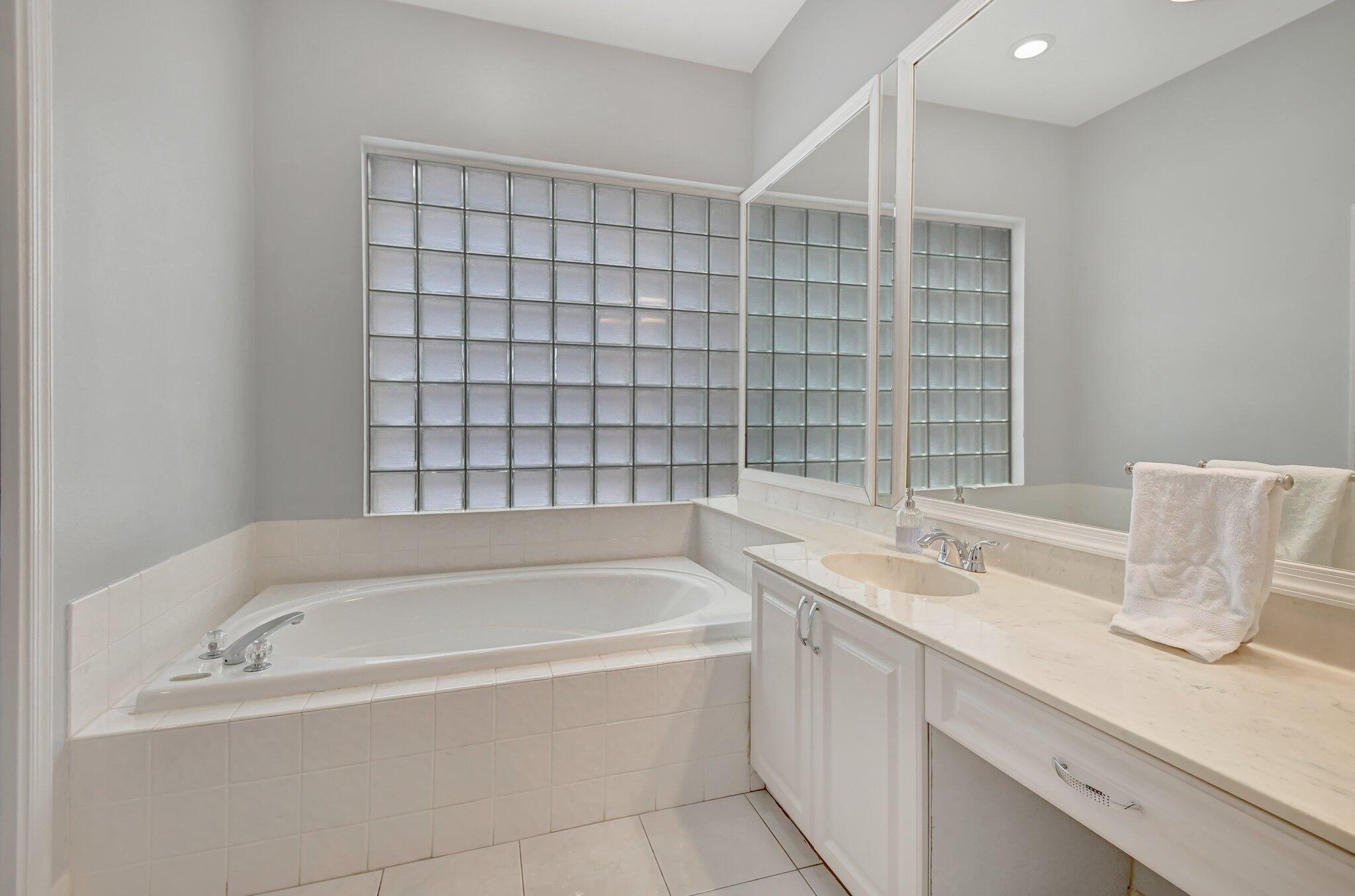 10929 Old Bridgeport Lane Boca Raton, FL 33498 - Photo 18 of 43 Primary bathtub mirrors and vanity