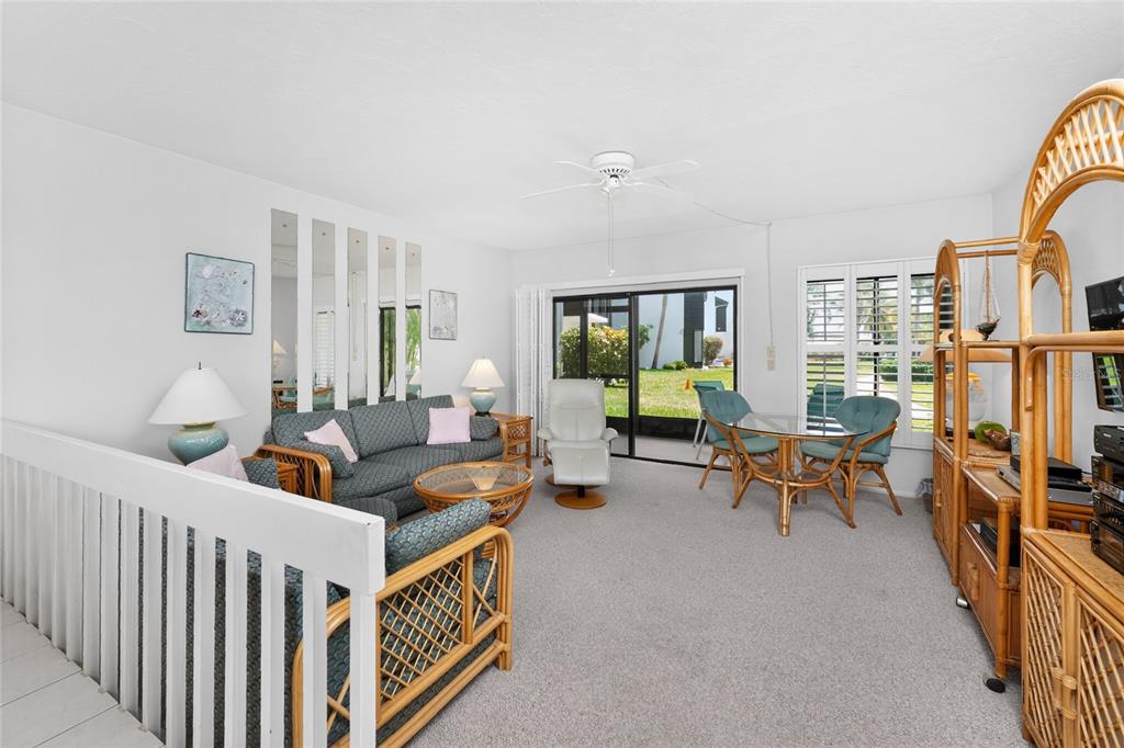 2955 North Beach Road, Unit B614 Englewood, FL 34223 - Photo 6 of 67 a living room with furniture and a flat screen tv