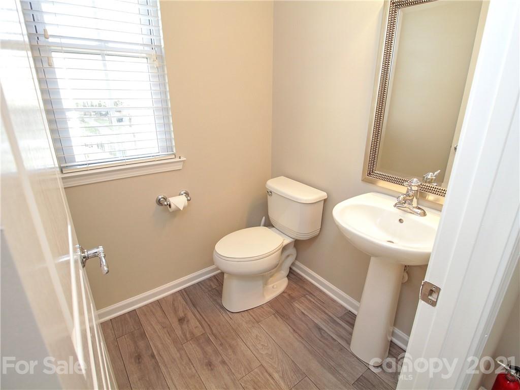629 6th Baxter Crossing Fort Mill, SC 29708 - Photo 11 of 31 a white toilet sitting next to a bathroom sink