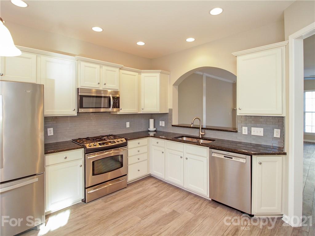 629 6th Baxter Crossing Fort Mill, SC 29708 - Photo 6 of 31 a kitchen with stainless steel appliances granite countertop a stove a sink and a refrigerator