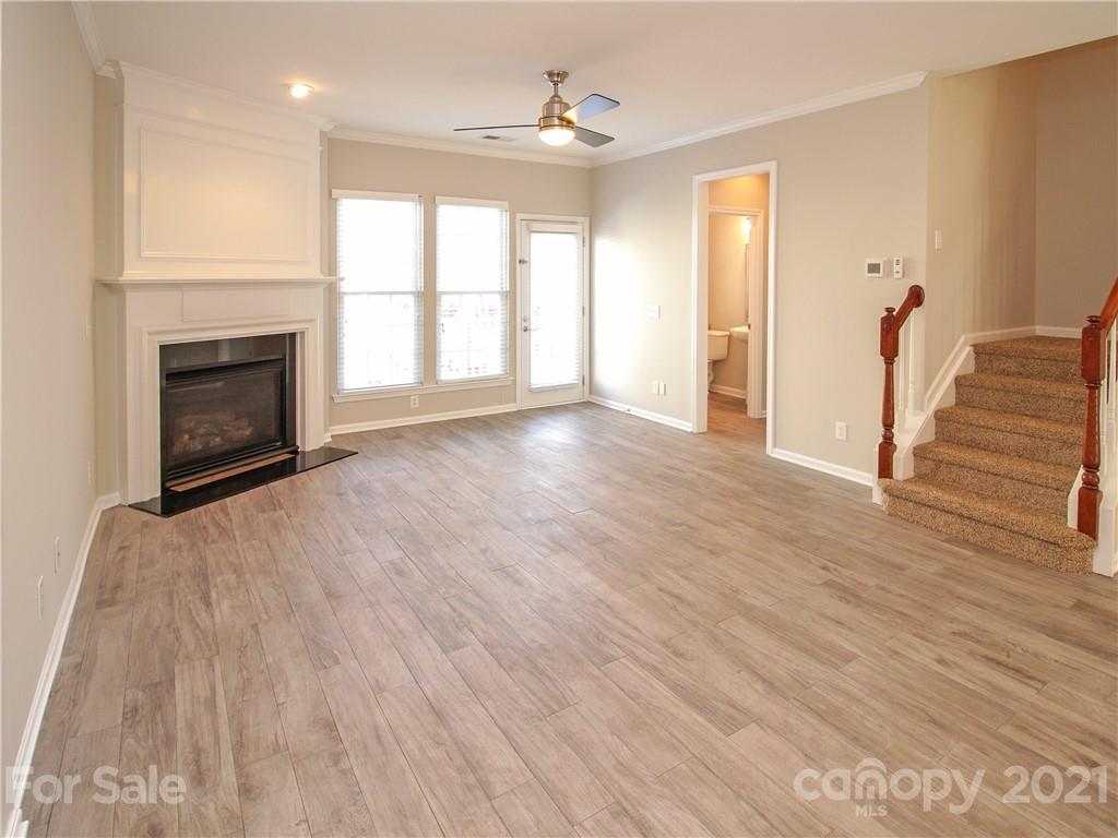 629 6th Baxter Crossing Fort Mill, SC 29708 - Photo 9 of 31 a view of empty room with wooden floor and fireplace