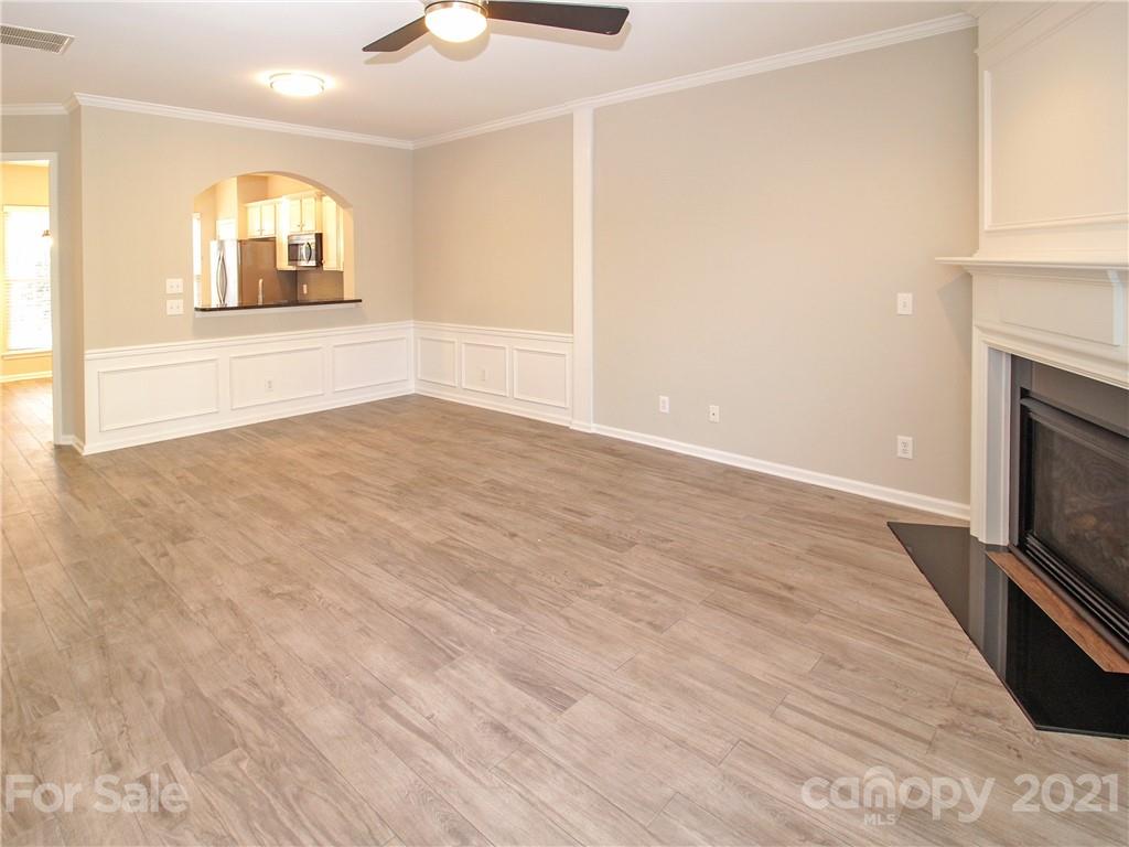 629 6th Baxter Crossing Fort Mill, SC 29708 - Photo 10 of 31 an empty room with wooden floor fireplace and windows