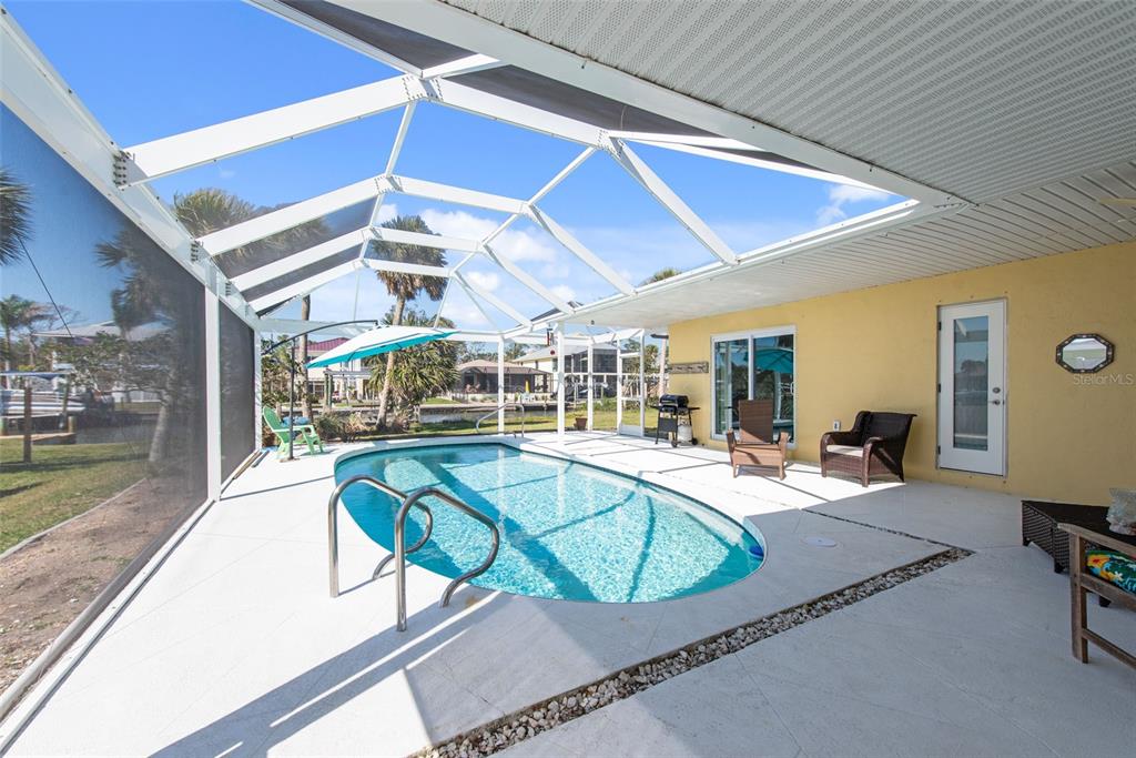 840 Park Road Englewood, FL 34223 - Photo 14 of 76 a view of a swimming pool with a patio