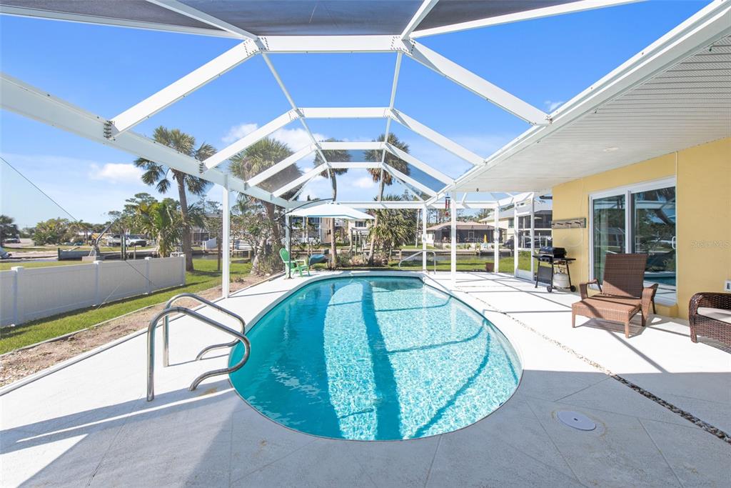 840 Park Road Englewood, FL 34223 - Photo 15 of 76 a view of a swimming pool with a patio