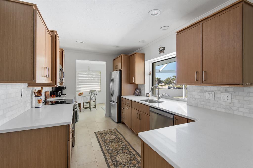 840 Park Road Englewood, FL 34223 - Photo 19 of 76 a large kitchen with a sink and cabinets