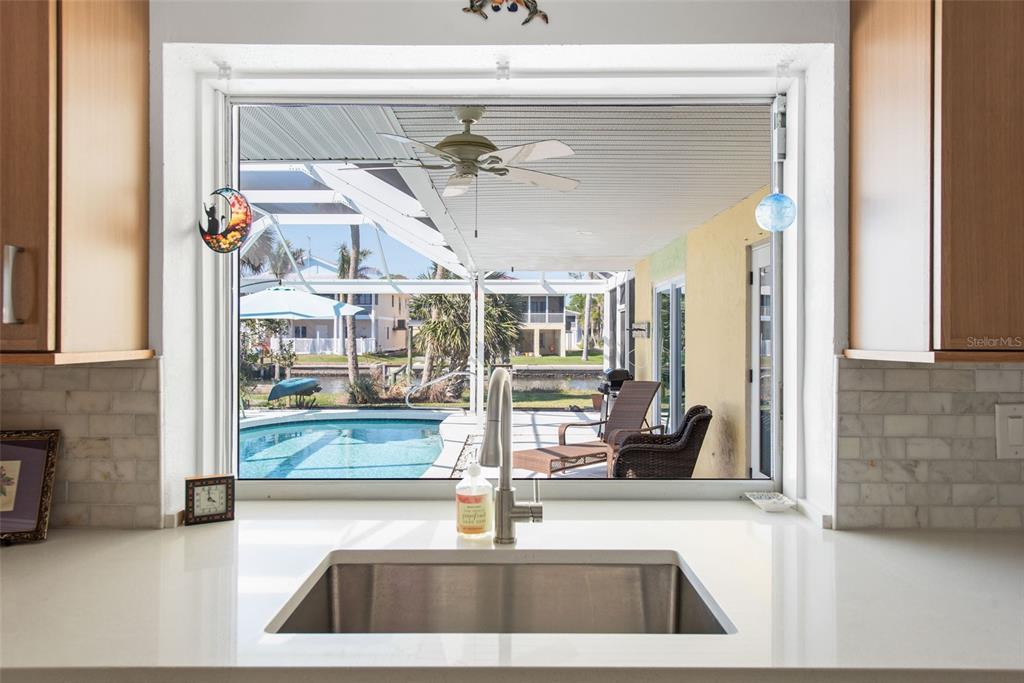 840 Park Road Englewood, FL 34223 - Photo 22 of 76 a kitchen with a sink and a mirror