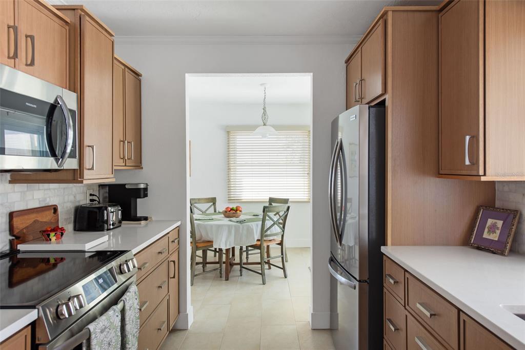 840 Park Road Englewood, FL 34223 - Photo 25 of 76 a kitchen with stainless steel appliances a sink stove and cabinets