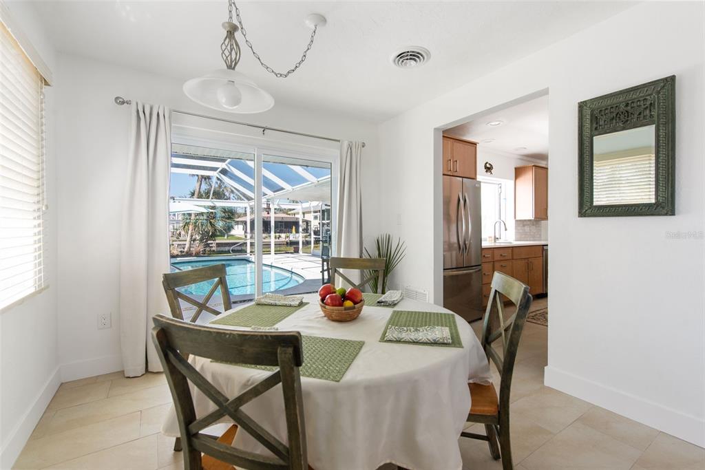840 Park Road Englewood, FL 34223 - Photo 28 of 76 a dining room with furniture a chandelier and window