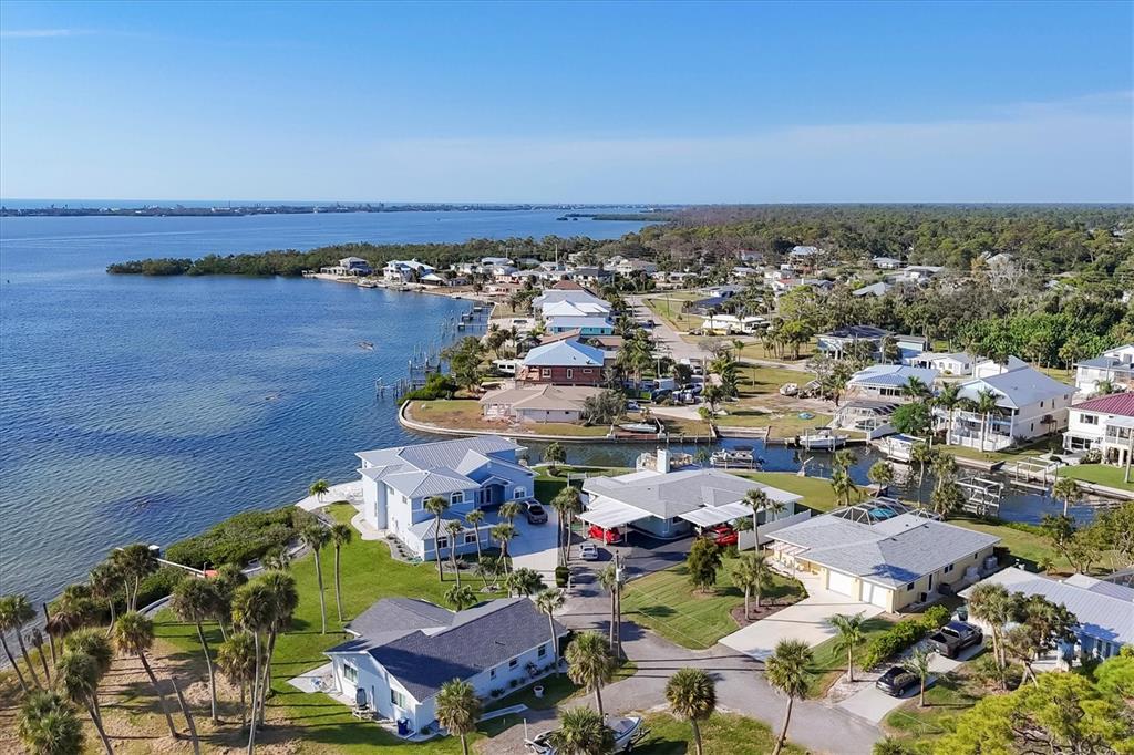 840 Park Road Englewood, FL 34223 - Photo 57 of 76 an aerial view of a city with lots of residential buildings and ocean view in back