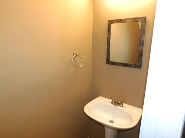a bathroom with a sink and mirror