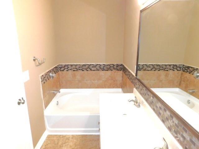 1795 Devon Drive Atlanta, GA 30311 - Photo 17 of 26 a bathroom with a bathtub and shower