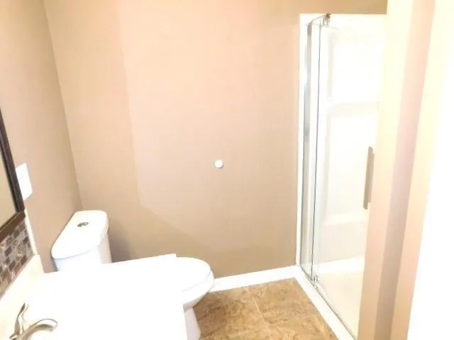 a bathroom with a toilet and shower