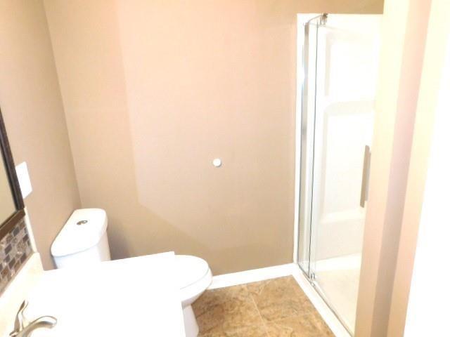 1795 Devon Drive Atlanta, GA 30311 - Photo 20 of 26 a bathroom with a toilet and shower