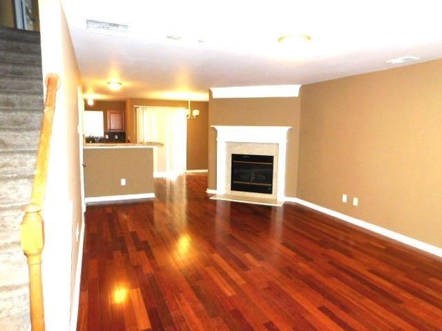 1795 Devon Drive Atlanta, GA 30311 - Photo 5 of 26 a view of empty room with wooden floor and fireplace