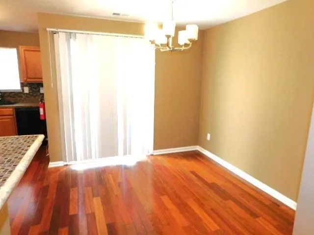 a view of a bedroom with wooden floor and a window