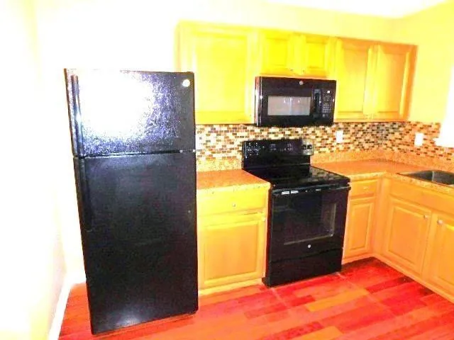 a kitchen with a sink and a refrigerator