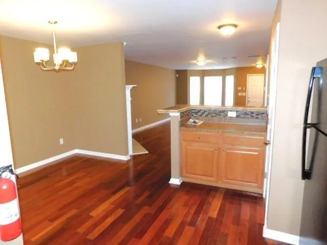 a view of a room with wooden floor