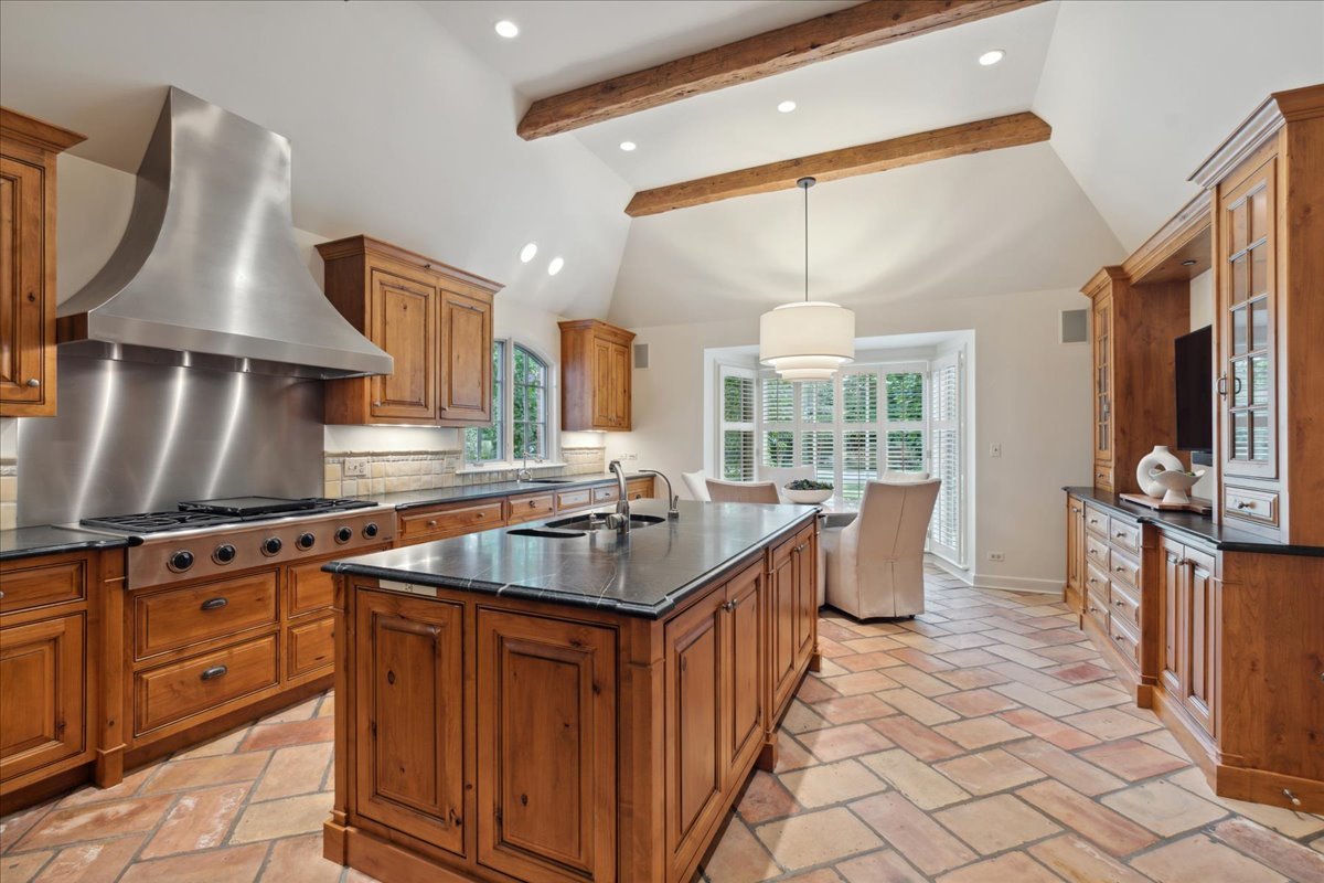 999 Hill Road Winnetka, IL 60093 - Photo 17 of 52 a kitchen with stainless steel appliances granite countertop a stove a sink and a refrigerator
