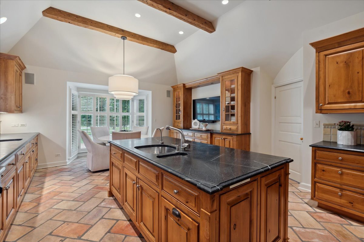 999 Hill Road Winnetka, IL 60093 - Photo 18 of 52 a kitchen with stainless steel appliances a sink stove and cabinets
