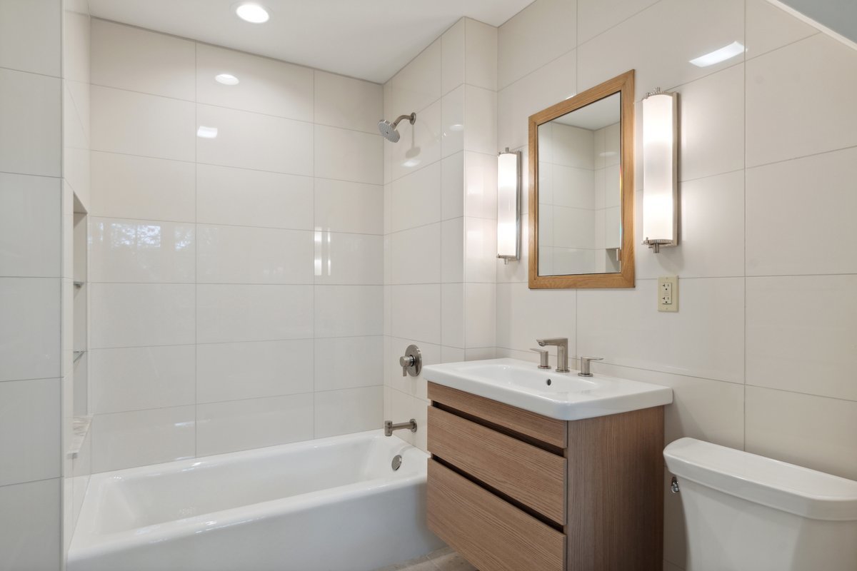 999 Hill Road Winnetka, IL 60093 - Photo 34 of 52 a bathroom with a bathtub shower sink vanity and toilet