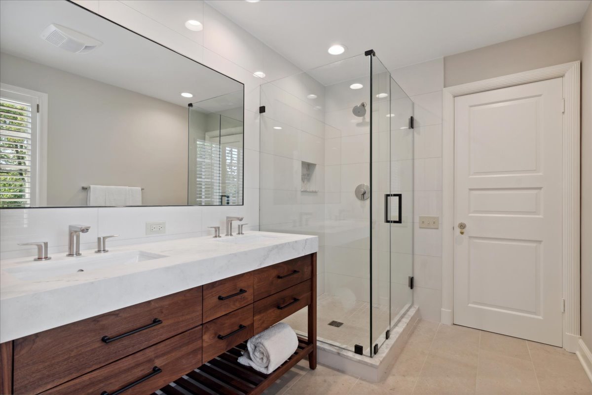 999 Hill Road Winnetka, IL 60093 - Photo 37 of 52 a spacious bathroom with a shower sink and mirror
