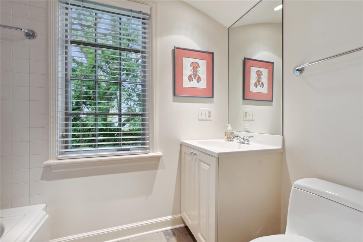 999 Hill Road Winnetka, IL 60093 - Photo 39 of 52 a bathroom with a sink a toilet and a window