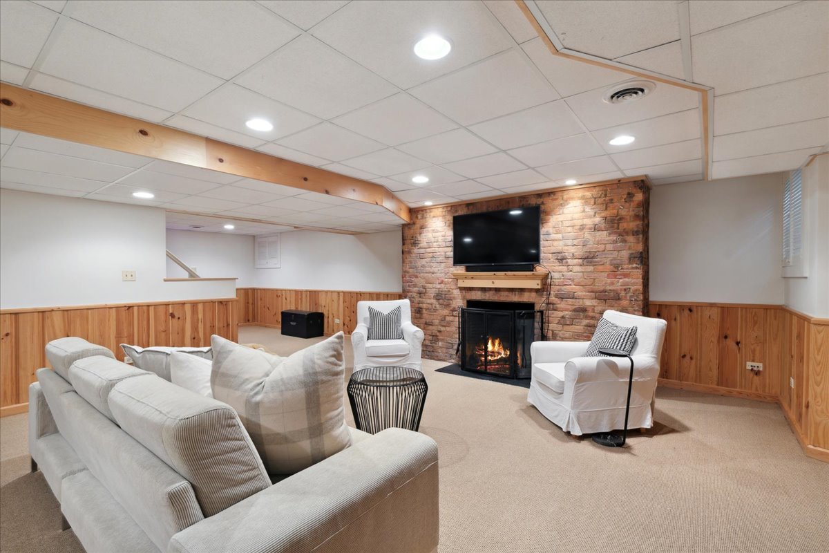 999 Hill Road Winnetka, IL 60093 - Photo 40 of 52 a living room with furniture a fireplace and a flat screen tv